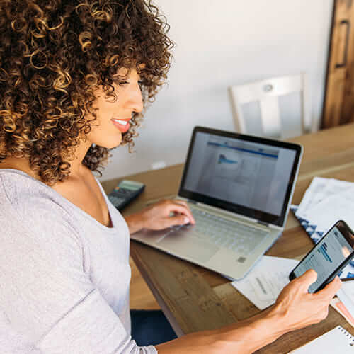 young woman calculating finances with laptop