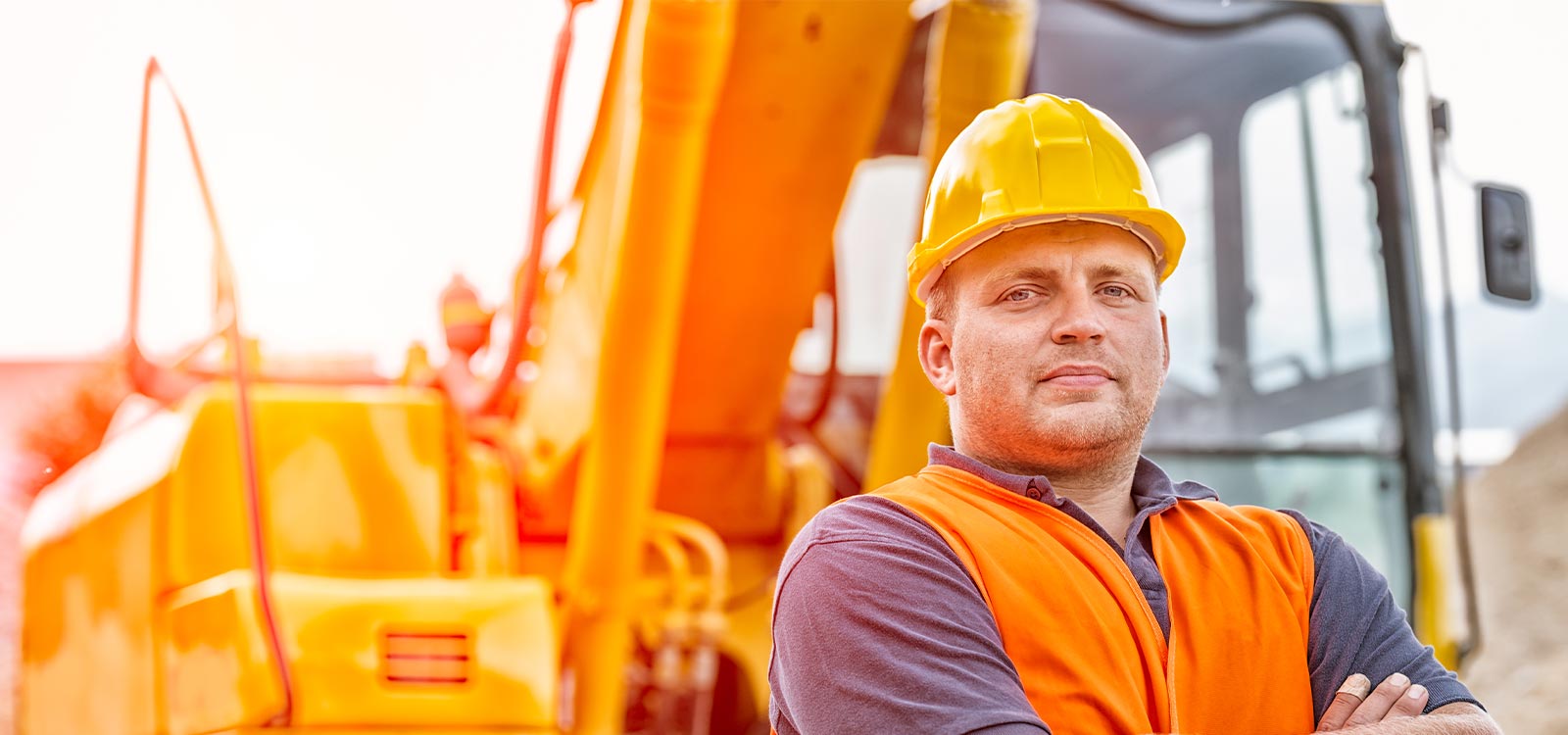 construction worker standing in front of site