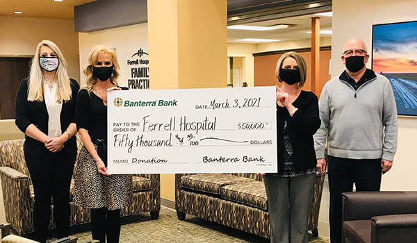 Ferrell staff posing with big check