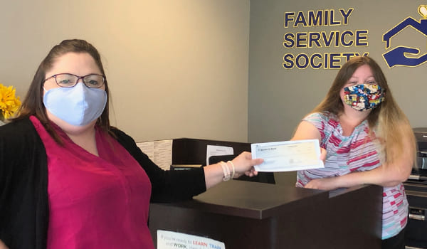 Paducah ladies holding check at desk