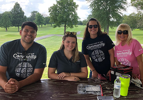 group photo under awning at golf course