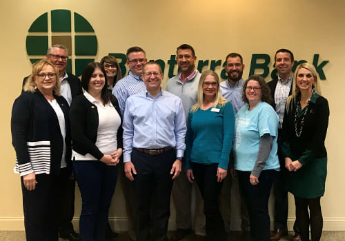 group photo of Banterra staff with signage behind