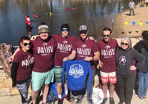 group photo in front of water