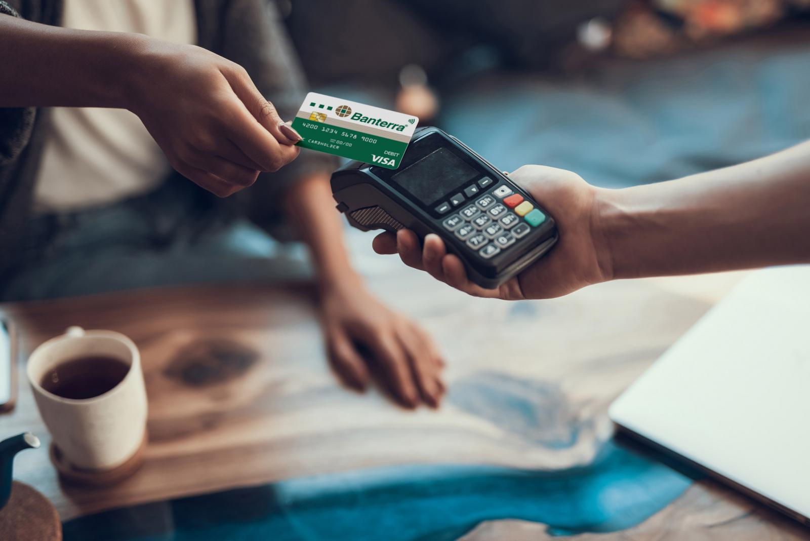 person making contactless payment with Banterra debit card