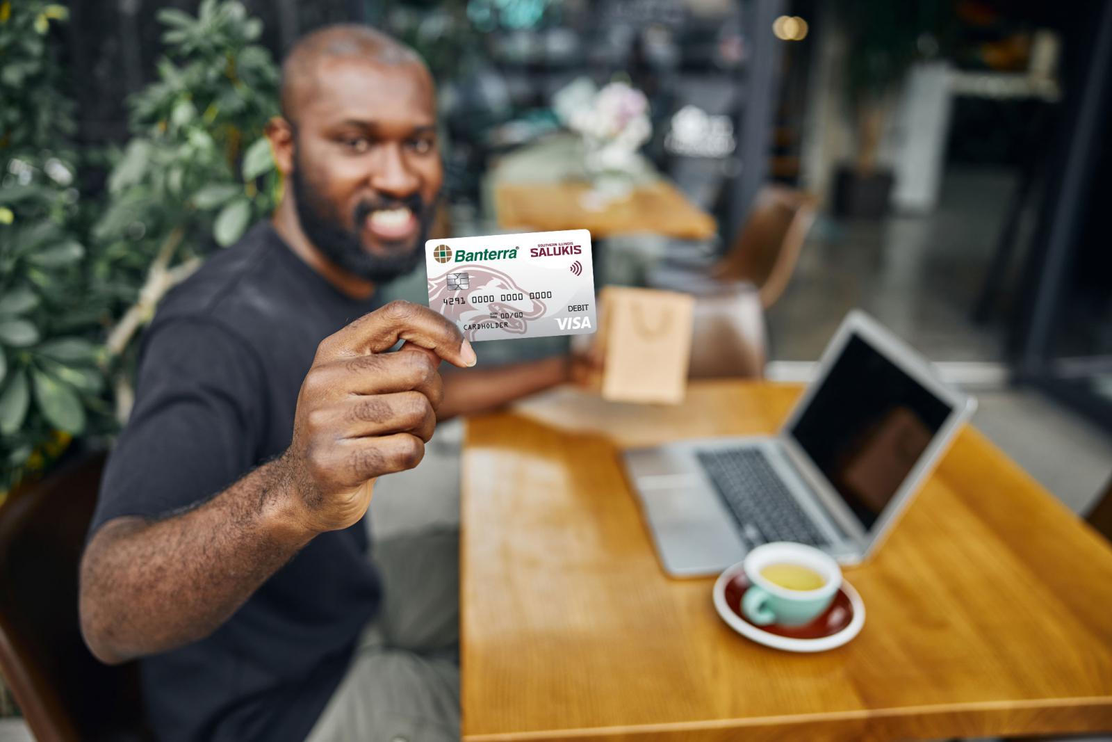 Man holding the Banterra-SIU Saluki Debit Card with EMV-Chip showing