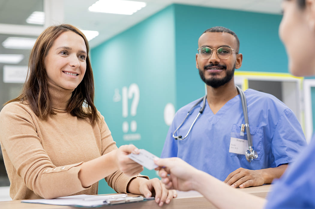 woman paying medical staff for services