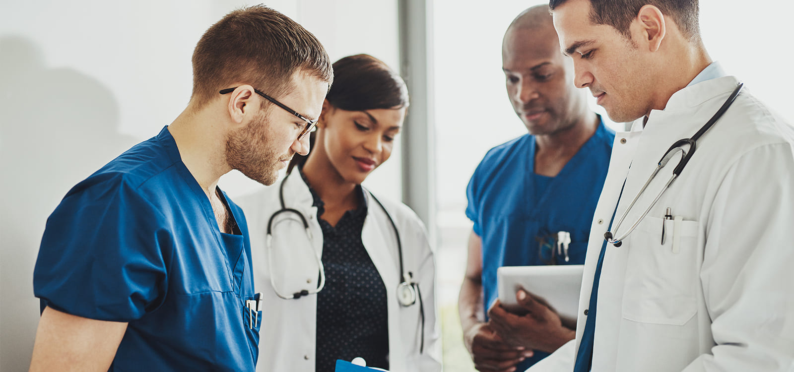 group of young doctors standing chatting